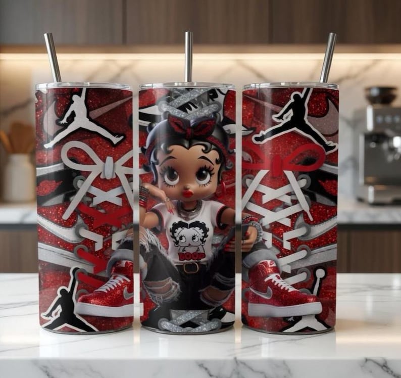 May include: Three stainless steel tumblers with straws. The tumblers feature a red glitter design with white shoelaces and a black silhouette of a person jumping. A cartoon Betty Boop character is in the center tumbler, wearing a white shirt with a graphic.