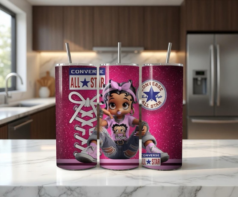 May include: A set of three stainless steel tumblers with lids and straws. The tumblers feature a pink glitter background with a cartoon Betty Boop character wearing a pink shirt and blue jeans. The tumblers also have the Converse All Star logo.