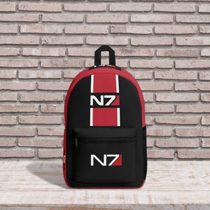 May include: A black and red backpack with a white N7 logo. The backpack has a zipped pocket on the front.