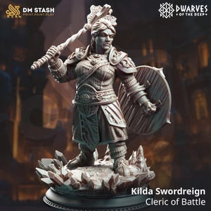 May include: A detailed miniature figurine of a female warrior, Kilda Swordreign, Cleric of Battle, holding a weapon and shield. The figurine is painted in a grey color and stands on a base with a crystal-like texture.