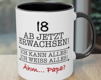 May include: White ceramic mug with a black rim and handle. The mug has black text that reads "18 AB JETZT ERWACHSEN! ICH KANN ALLES! ICH WEISS ALLES!" and red text that reads "Ähm... Papa?"