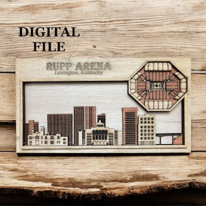 May include: Wooden laser-cut artwork featuring a cityscape and Rupp Arena in Lexington, Kentucky. The artwork includes the text "DIGITAL FILE" and "RUPP ARENA Lexington, Kentucky". The design is in shades of brown and beige.