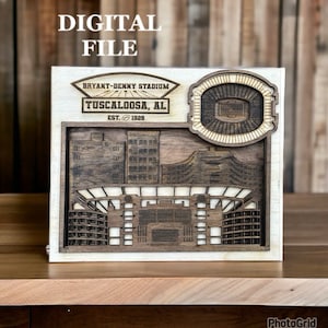 May include: A digital file of a wooden laser cut model of Bryant-Denny Stadium in Tuscaloosa, Alabama. The model includes the stadium's seating chart and a small inset of the stadium's exterior. The text "Bryant-Denny Stadium Tuscaloosa, AL Est. 1929" is visible on the model.