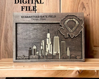 May include: A wood-framed digital file of a skyline with the text "Guaranteed Rate Field Chicago, Illinois" above the skyline. The skyline includes the Willis Tower, the John Hancock Centre, and other buildings. The frame is dark brown and the skyline is light brown.