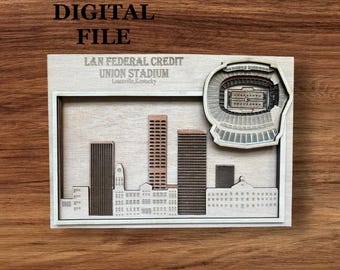May include: A wooden relief sculpture of a cityscape, featuring a stadium and several buildings. The text "DIGITAL FILE" is at the top, with "L&N FEDERAL CREDIT UNION STADIUM Louisville, Kentucky" below. The sculpture is set in a wooden frame.