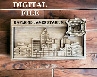 May include: A wooden cutout of the Tampa Bay Buccaneers Raymond James Stadium skyline. The stadium is depicted in the background with the city skyline in the foreground. The words "Let's Go Bucs!" are on a sign in the foreground.