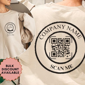 May include: A beige sweatshirt with a black logo on the front that says "YOUR LOGO HERE" and a black circle on the back with the text "COMPANY NAME" and a QR code that says "SCAN ME".
