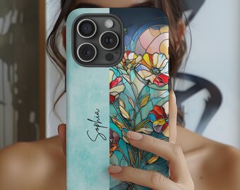 May include: A personalized phone case with a stained glass design featuring colorful flowers and the name "Sophia" printed on the left side.
