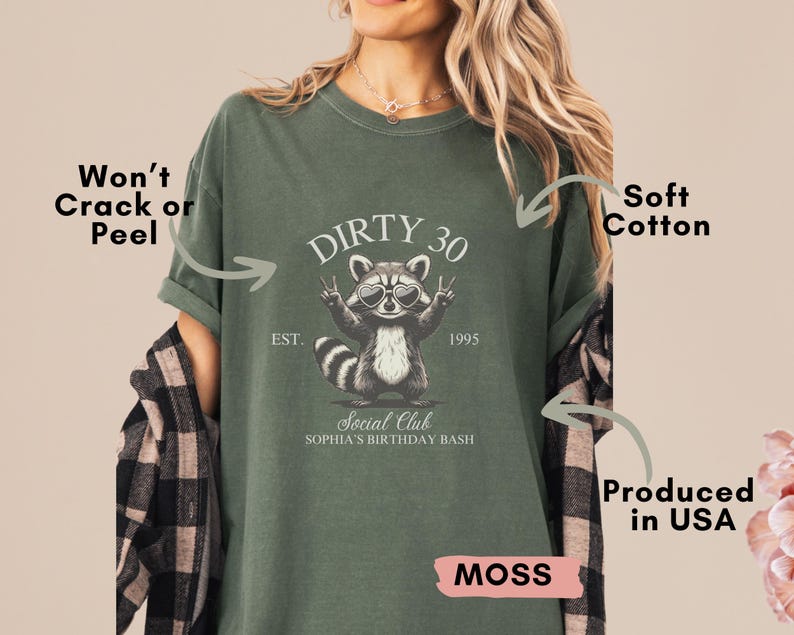 May include: A moss green t-shirt with a raccoon graphic and the text "Dirty 30 Social Club Sophia's Birthday Bash" printed on the front. The shirt is made of soft cotton and is produced in the USA.