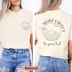 May include: Cream-colored t-shirt with a front and back design. The front features a circular graphic with text, while the back displays a larger design with the words "MOST LIKELY" and "to your text". The shirt is paired with blue jeans.