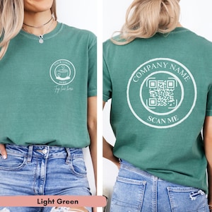 May include: A light green t-shirt with a white circle on the front that says "Your Logo Here" and a white circle on the back that says "Company Name" with a QR code and "Scan Me".