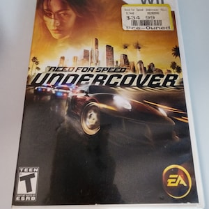 May include: A video game case for the Wii console featuring Need for Speed: Undercover. The case is yellow and black with a picture of a car driving through a city at night. The game is rated T for Teen by the ESRB.