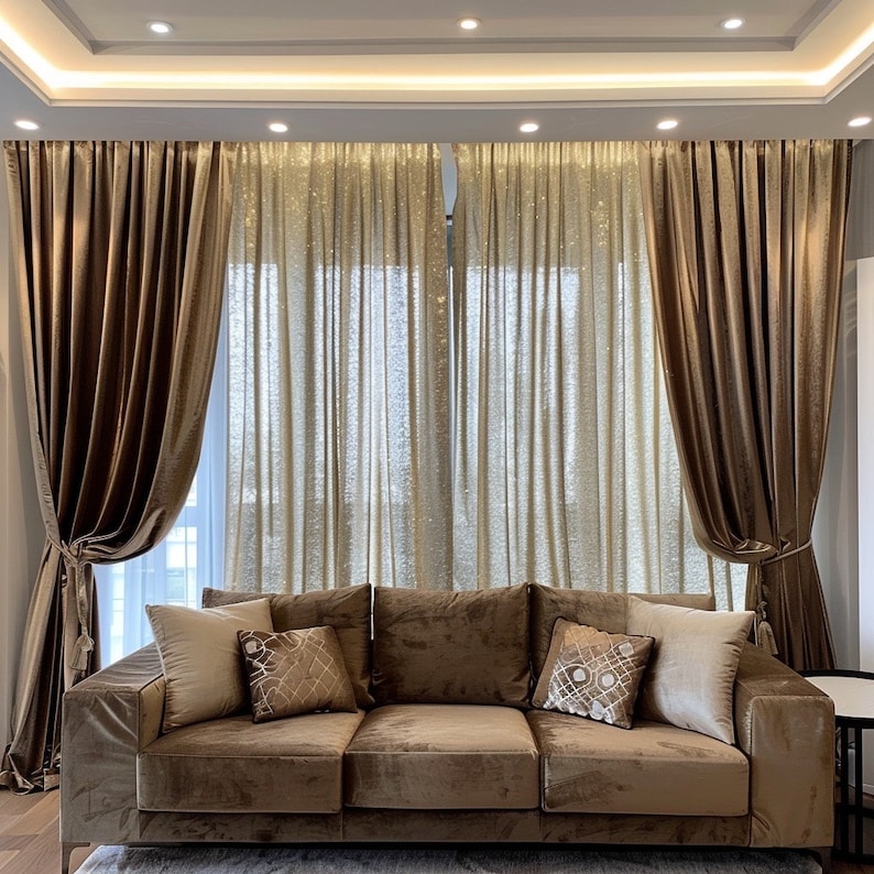 May include: A brown velvet sofa with three cushions and a patterned throw pillow. The sofa is in front of a window with brown velvet curtains and sheer gold curtains.