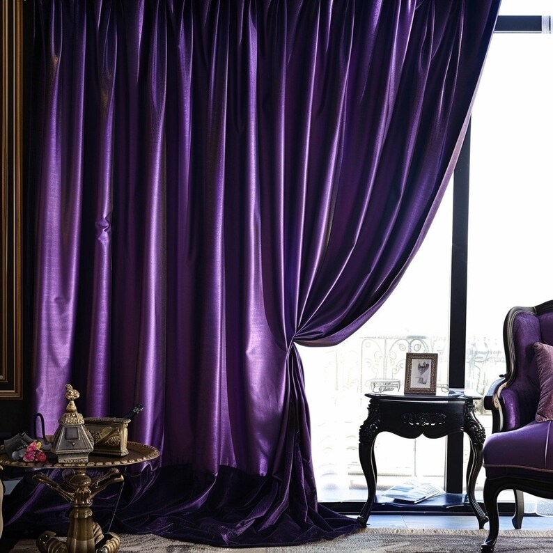 May include: Purple velvet curtains with a satin sheen, hanging in a room with a side table and a chair. The curtains are drawn back to reveal a window with a view of the outdoors.