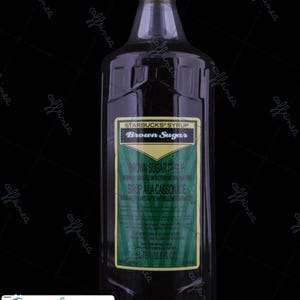 May include: A large plastic bottle of Starbucks Brown Sugar syrup with a tan screw-top cap. The label features green and gold accents with the text Starbucks Syrup Brown Sugar, Sirop à la Cassonade, and a volume of 1 Liter (33.8 fl oz).
