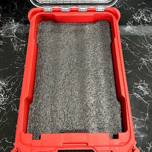 May include: Red tool box with a black foam insert. The box has a clear lid and a latch on the side.