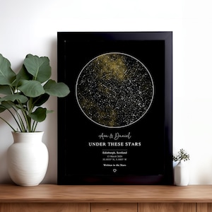 May include: A framed rectangular wall art print featuring a circular gold and black star map. The text reads: Ava & Daniel, UNDER THESE STARS, Edinburgh, Scotland, 13 March 2024, 55.9533 N, 3.1883 W, Written in the Stars, with a small heart icon.