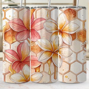 May include: A floral tumbler with a watercolour design of pink and white flowers with yellow centres, set against a honeycomb pattern. The design includes dripping honey accents, creating a nature-inspired aesthetic.