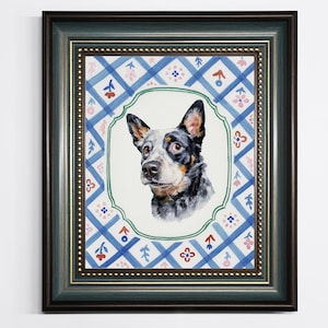 May include: A framed watercolour portrait of a blue heeler dog. The dog's head is in a green and white oval, set against a blue and white patterned background. The frame is dark green with gold accents.