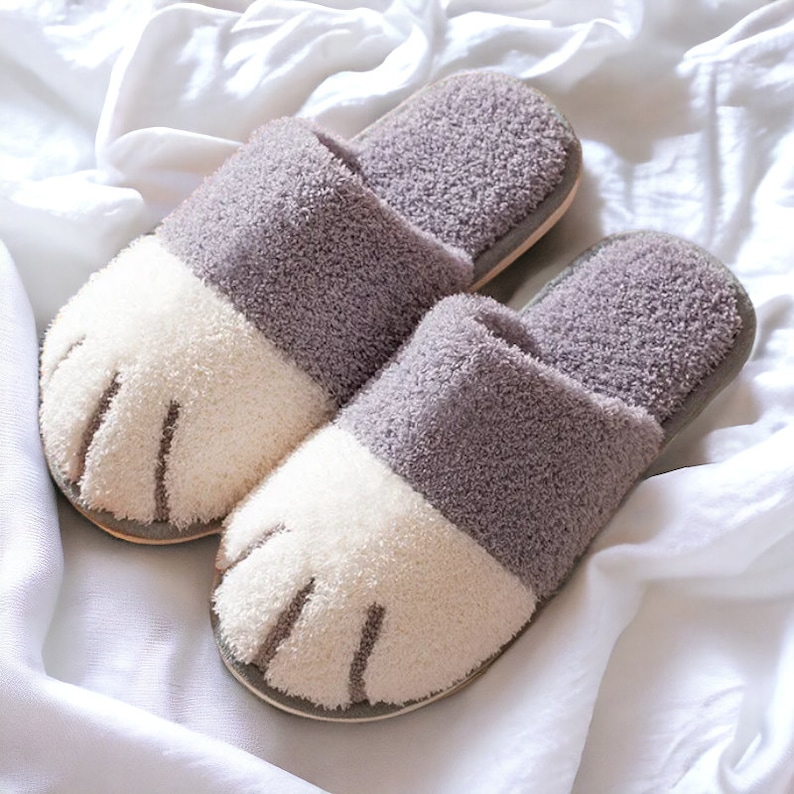 Gray plush slippers designed like cat paws, soft and warm for indoor use.