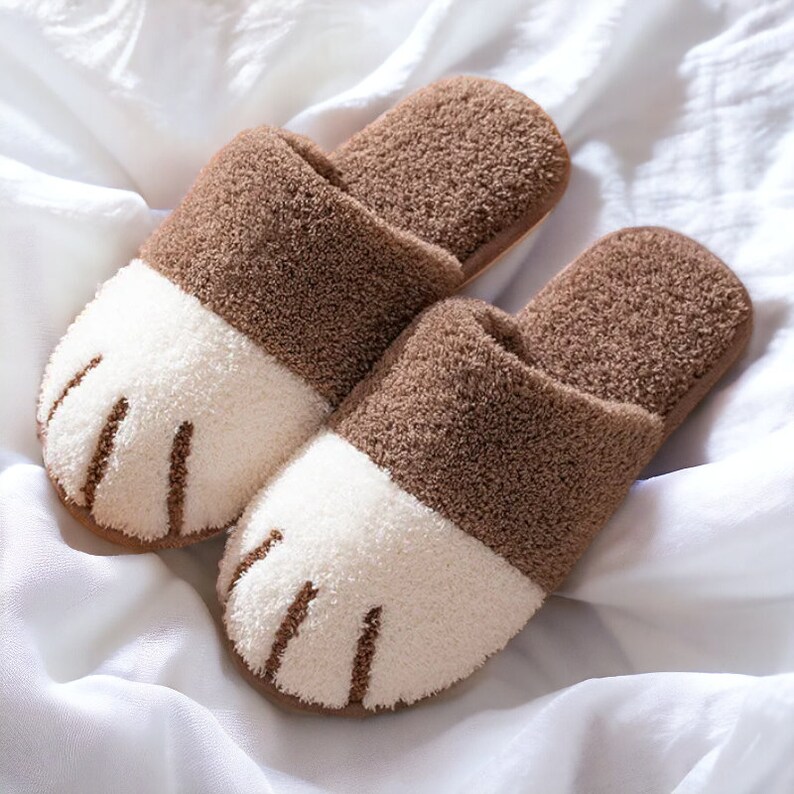Brown plush slippers designed like cat paws, soft and warm for indoor use.