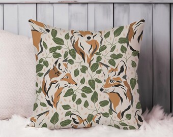 May include: A beige throw pillow with a repeating pattern of stylized foxes and green leaves. The foxes are orange and brown with black accents.