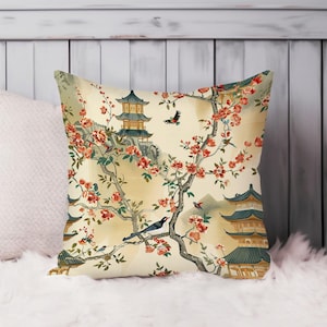 May include: A decorative throw pillow with a cream background featuring a repeating pattern of cherry blossom branches, pagodas, and birds. The pillow has a traditional Asian design.