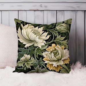 May include: A decorative pillow with a floral pattern. The pillow features large white and yellow flowers with green leaves on a black background.