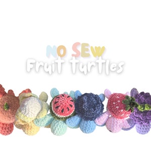 May include: A set of six crocheted fruit turtles. The turtles are made in a variety of colors, including pink, yellow, green, blue, and purple. Each turtle has a different fruit on its back, including a watermelon, a blueberry, a strawberry, a pineapple, a lemon, and a grape. The turtles are arranged in a row, with the watermelon turtle at the front and the grape turtle at the back. The text "NO SEW Fruit Turtles" is written above the turtles.