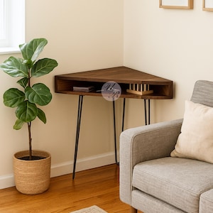 May include: A dark brown corner table with black hairpin legs. The table has a triangular top with a built-in shelf. A potted plant and a gray sofa are in the background.
