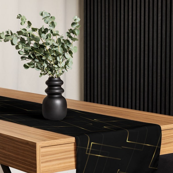 Chemin de table design décoratif en tissu résilient noir et or et imprimé intégral pour une salle à manger et une table élégantes
