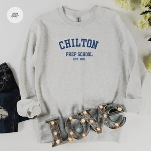 May include: Ash grey sweatshirt with the text "Chilton Prep School Est. 1803" in blue.