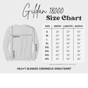 May include: Size chart for Gildan 18000 heavy blended crewneck sweatshirt. The chart shows measurements in inches for width, length, and sleeve length for sizes S through 5XL.