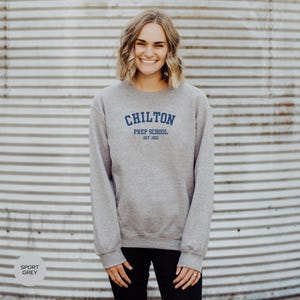 May include: A gray sweatshirt with the text "Chilton Prep School Est. 1903" in blue.