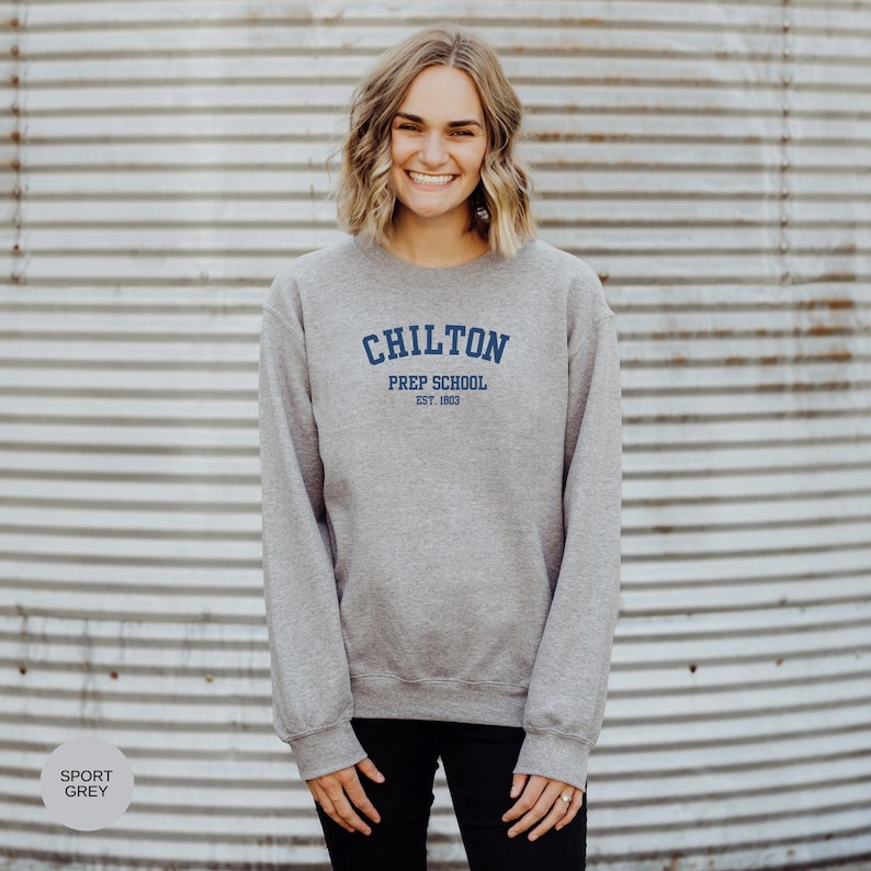 May include: A gray sweatshirt with the text "Chilton Prep School Est. 1903" in blue.