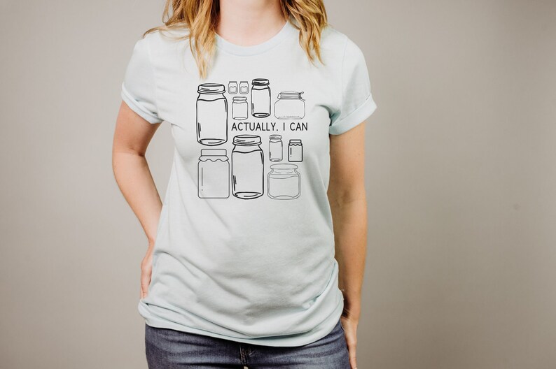 May include: A light blue t-shirt with a graphic of various jars and the text "Actually, I can".