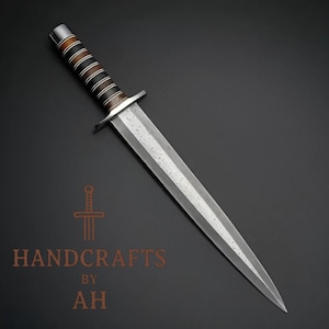 May include: A handcrafted dagger with a polished steel blade and a handle wrapped in alternating bands of brown and black leather. The blade has a central fuller and a pointed tip. The text "HANDCRAFTS BY AH" is visible.