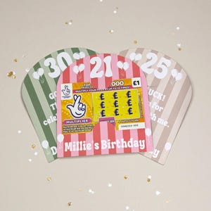 May include: Three birthday-themed scratch-off card holders. The center card is pink and white striped with a scratch-off ticket that says "Millie's Birthday". The other two are green and tan with the numbers 30, 21, and 25.