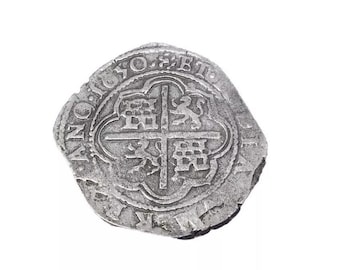May include: A silver coin with a cross and a lion on it. The coin has the inscription "NO. SE. TE. PU. DE. RE. AL. VE. MA. RE." around the edge.