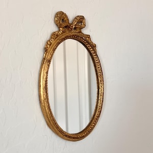 Vintage Italian Florentia Accent Oval Mirror Ribbon Bow Motif Gilded Gold Wall Hanging Decor Mirror Delicate Ornate Scrolled Frame Italy
