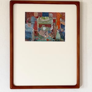 May include: A framed painting featuring an abstract interior scene with a table, a white cup, and green fruit. The artwork is enclosed in a rectangular wooden frame with a wide white mat border, showcasing a textured application of paint.