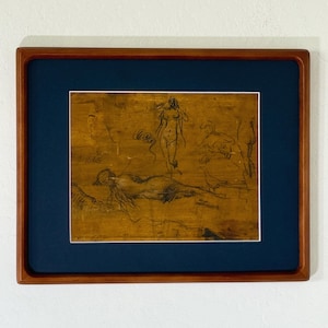 May include: A framed artwork featuring a mustard-yellow background with dark charcoal line drawings of multiple figures and a bird. The piece is enclosed in a dark blue mat and a polished wooden frame with a rectangular profile and rounded corners.