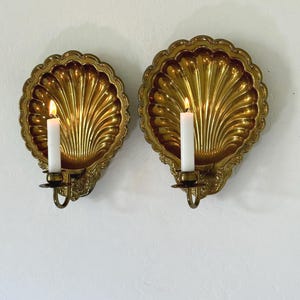 May include: A white ceramic mug with a black handle and the text "But First, Coffee" in a bold, black font. The mug sits on a white surface, showcasing its clean design.