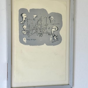 K&ouml;nnte beinhalten: Ein gerahmter Druck mit einer grauen zentralen Form, die schwarze Strichzeichnungen von vier stilisierten Figuren und ein komplexes R&ouml;hrennetzwerk enth&auml;lt. Der Text lautet "Juegos de mesa" und "...y por dentro". Nummeriert 8/15 und signiert.