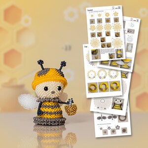A beaded bee with a yellow hat and golden honey bucket stands beside printed pattern sheets, illustrating the DIY beaded bee tutorial in Peyote Stitch.