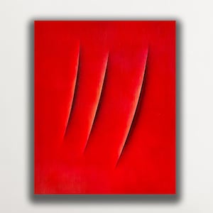 May include: A vibrant red abstract painting with three vertical, curved indentations. The artwork is displayed on a white wall above a beige sofa with decorative pillows. A modern floor lamp stands nearby.