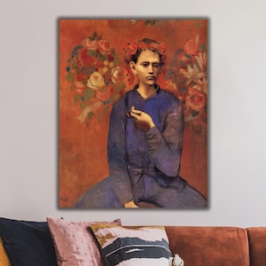 May include: A painting of a young person wearing a blue shirt and a wreath of flowers on their head. The person is holding a pipe in their right hand and is sitting in front of a background of red and orange flowers.