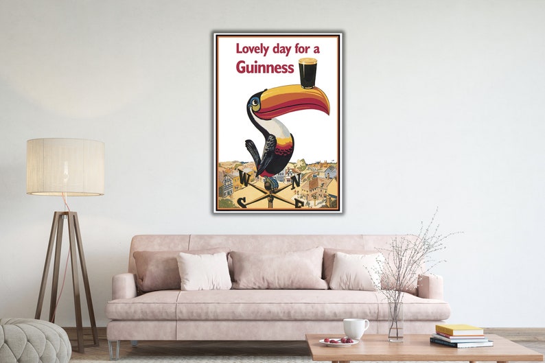 May include: A vintage Guinness advertisement featuring a toucan holding a glass of Guinness with the text "Lovely day for a Guinness".