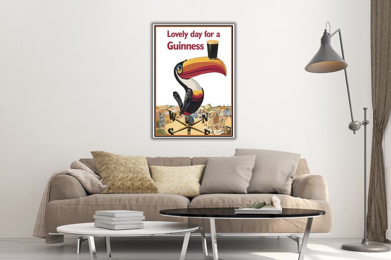 May include: A vintage Guinness advertisement featuring a toucan holding a glass of Guinness with the text "Lovely day for a Guinness".