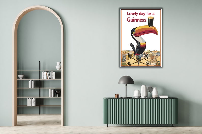 May include: A vintage Guinness advertisement featuring a toucan holding a glass of Guinness with the text "Lovely day for a Guinness".